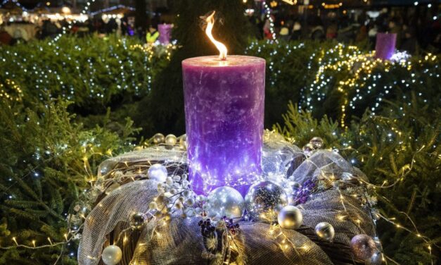 The first candle flame of Advent is lit